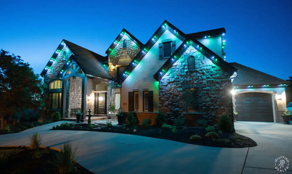 Stone home with blue and white roofline lighting