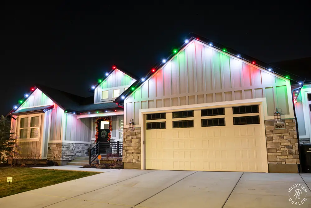 Farmhouse with red, green and white Christmas lighting