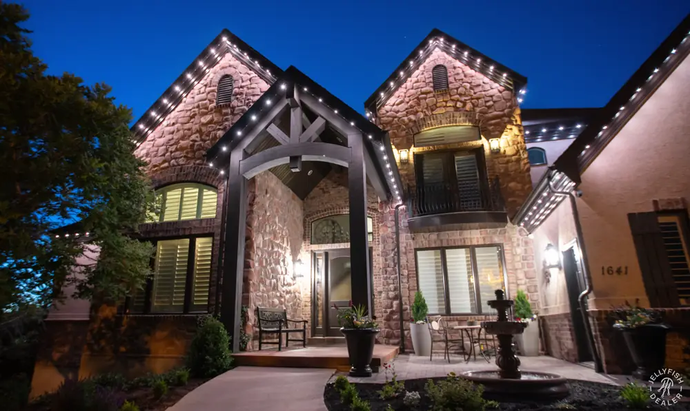 Stone home with warm white roofline lighting